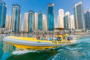mustsee a boat in the water with a city in the background