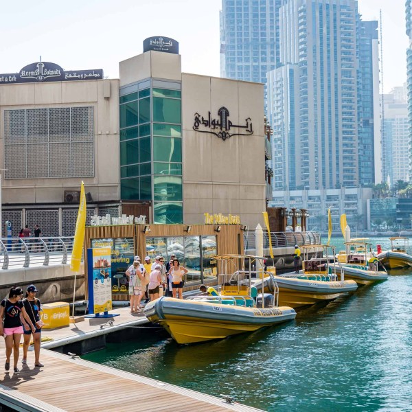a small boat in a body of water with a city in the background