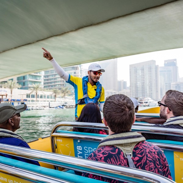 a group of people riding on the back of a boat