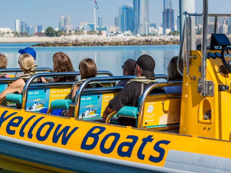 a group of people sitting in a boat on a body of water