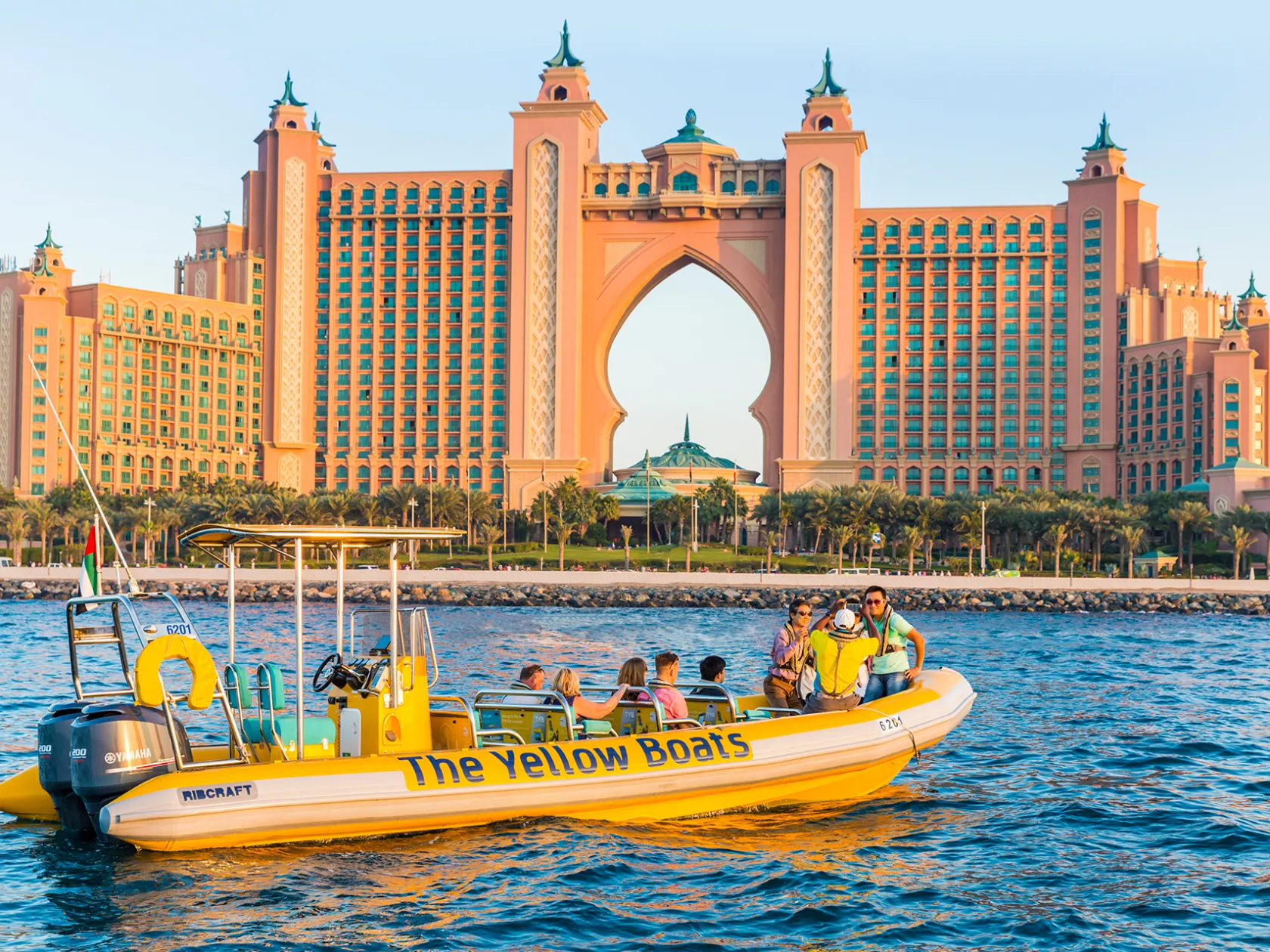 a boat on a body of water with Atlantis, The Palm in the background