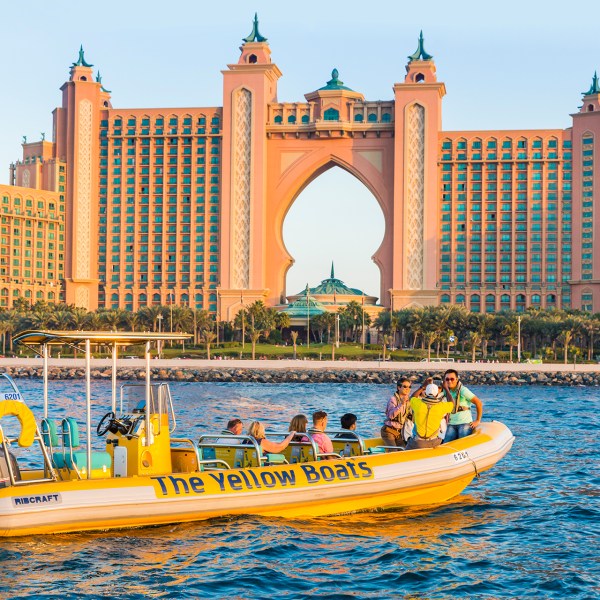 a boat on a body of water with Atlantis, The Palm in the background