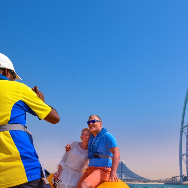 a couple of people that are standing in a clear blue sky