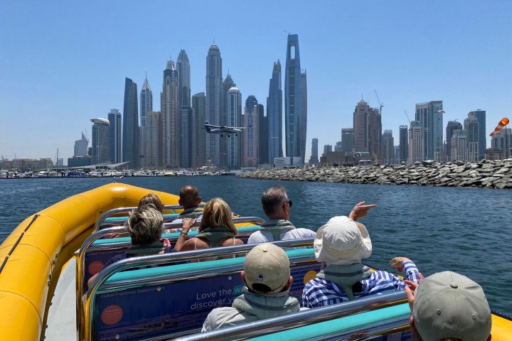 a group of people standing next to a body of water